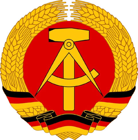 Runde Darstellung: auf rotem Grund ein goldener Hammer über einem geöffneten Zirkel, umschlossen von einem Ährenkranz, der unten von einem schwarz-rot-goldenen Band zusammengehalten wird.