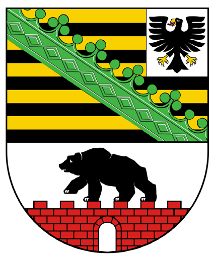 Wappenschild, oben geteilt: links schwarz-goldene Querbalken mit grünem Rautenkranz, rechts ein schwarzer Adler auf Weiß. Unten auf Weiß ein schwarzer Bär, der über eine rote Ziegelmauer schreitet.